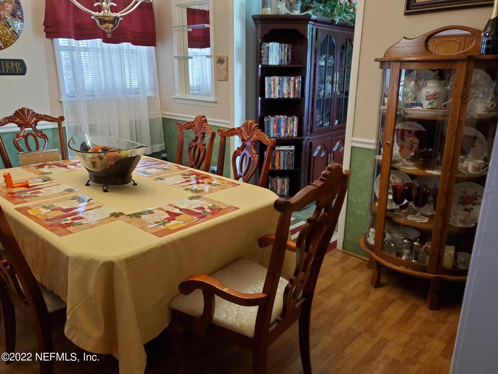 106 Comer Road Palatka, FL 32177 - Photo 11 of 19 a dining room with furniture and wooden floor