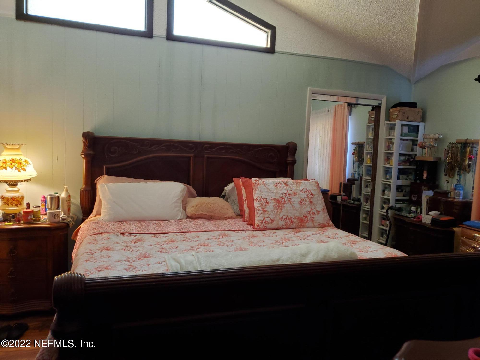 106 Comer Road Palatka, FL 32177 - Photo 13 of 19 a large bed sitting in a bedroom next to a window