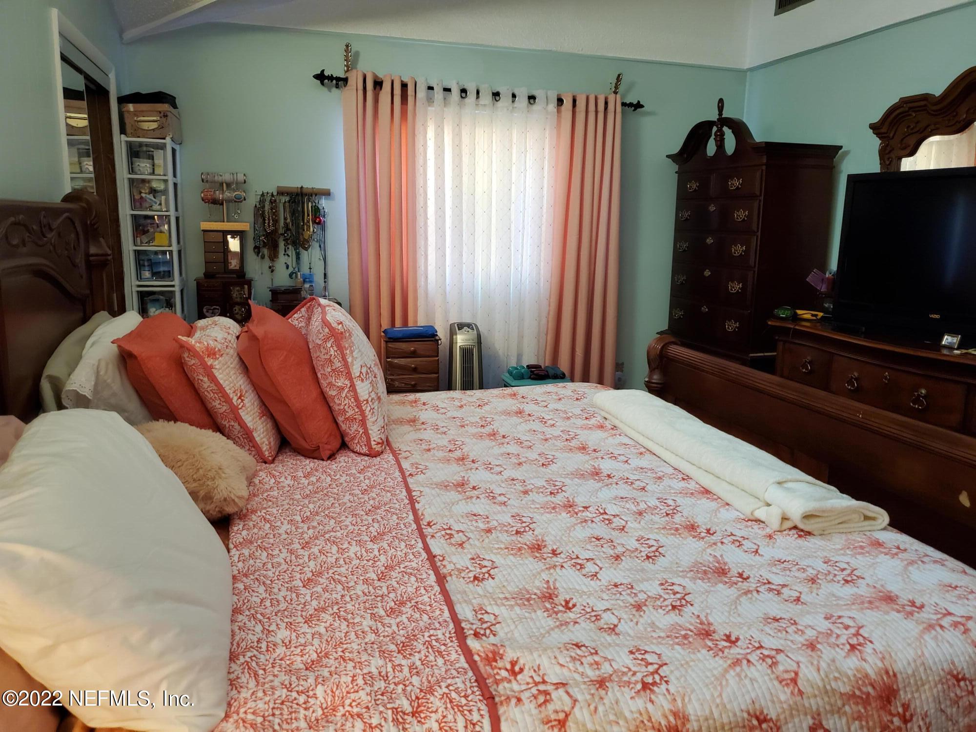 106 Comer Road Palatka, FL 32177 - Photo 14 of 19 a bedroom with a bed a television and a window