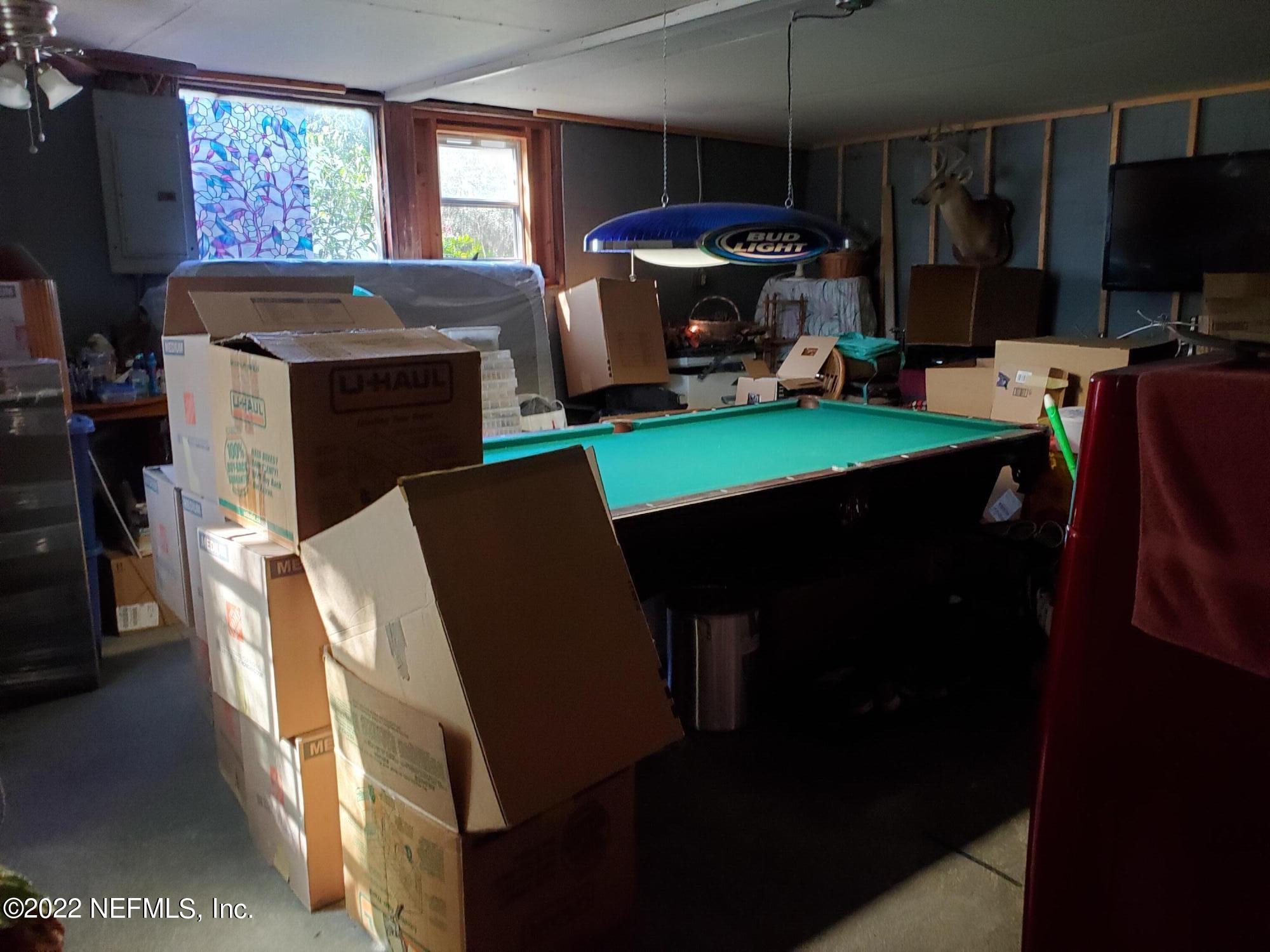 106 Comer Road Palatka, FL 32177 - Photo 18 of 19 a view of a dining room with furniture a fireplace and a flat screen tv