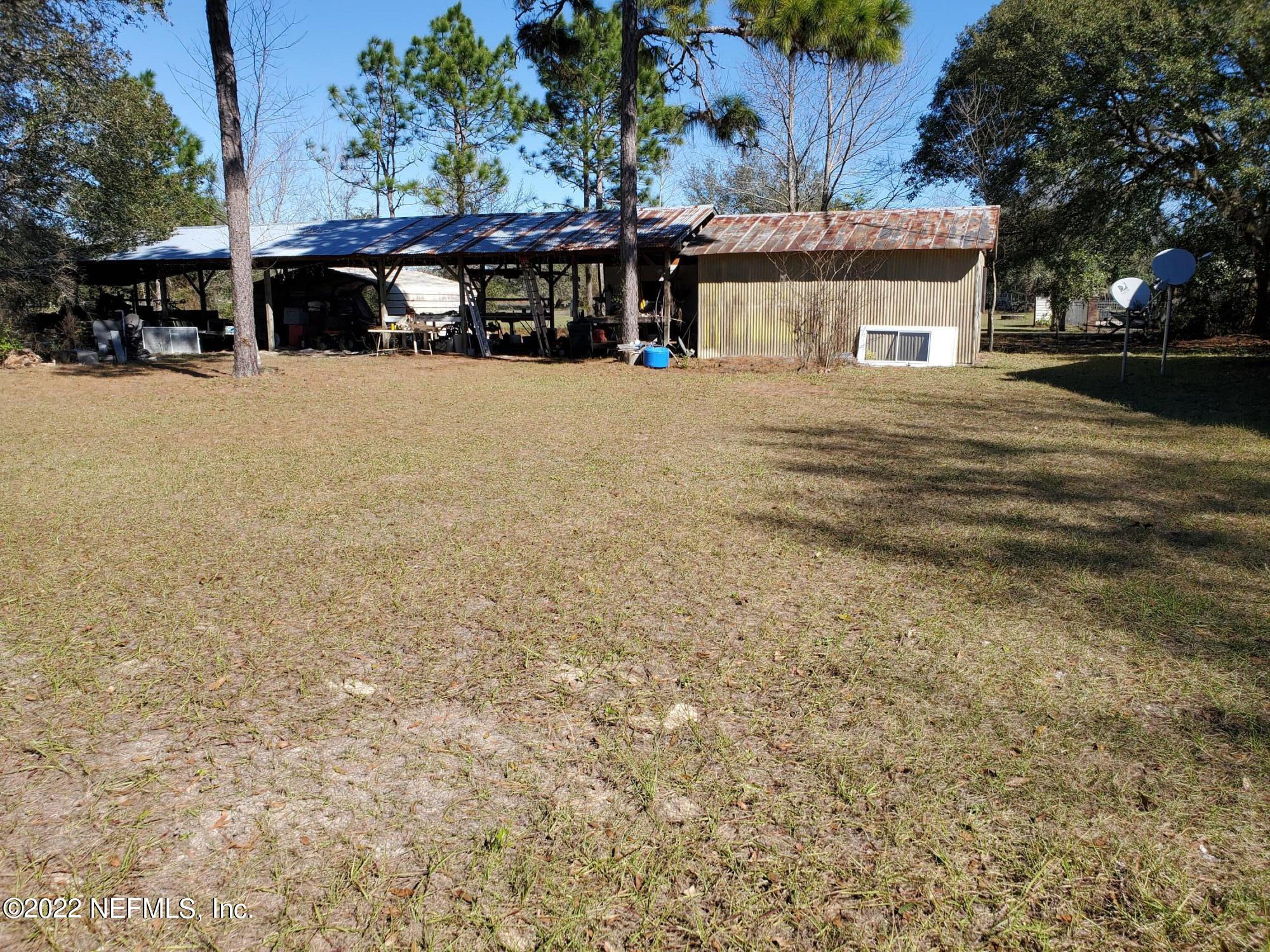 106 Comer Road Palatka, FL 32177 - Photo 19 of 19 a front view of house with yard and car parked