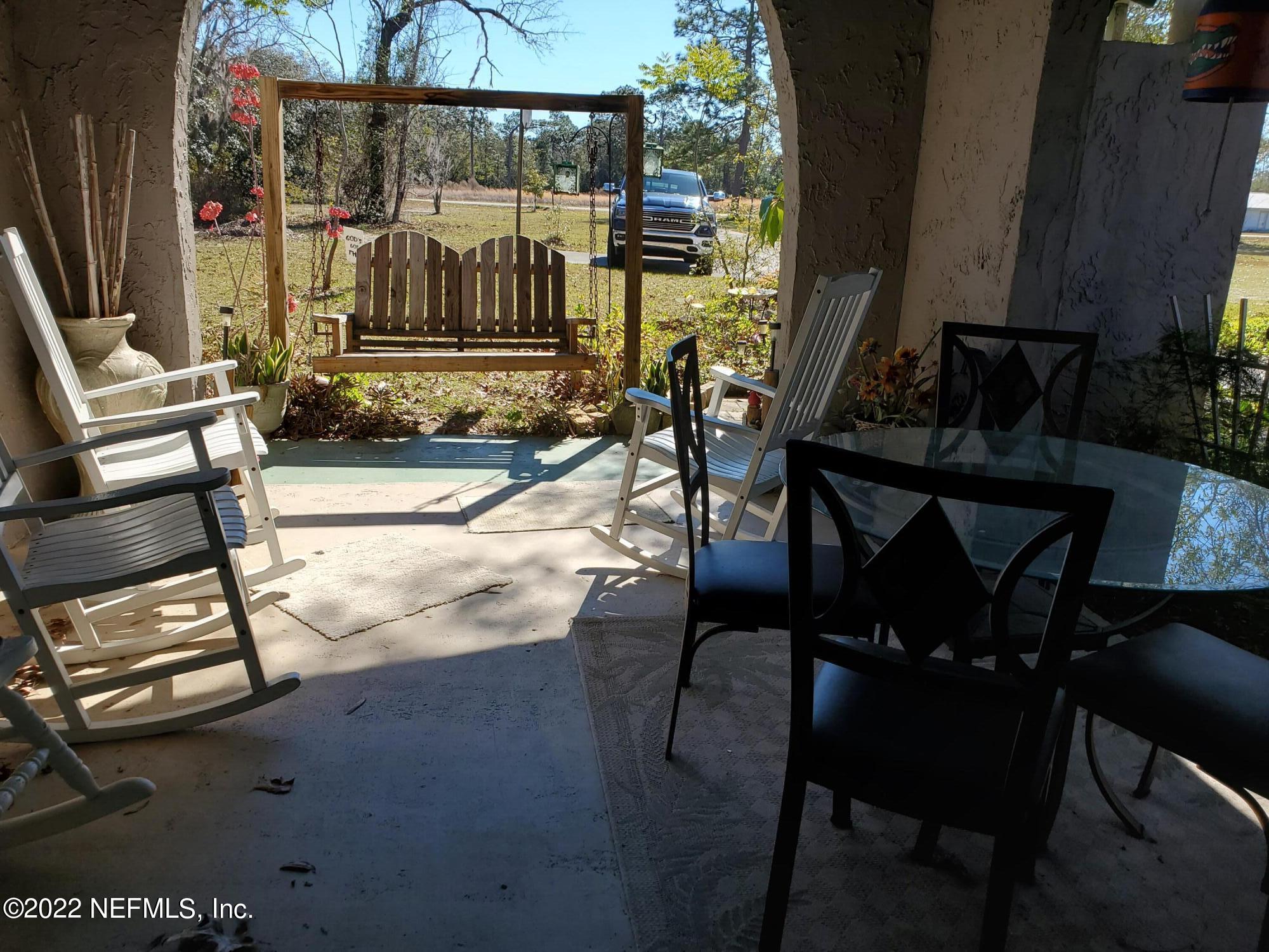 106 Comer Road Palatka, FL 32177 - Photo 3 of 19 a view of a patio with table and chairs and potted plants