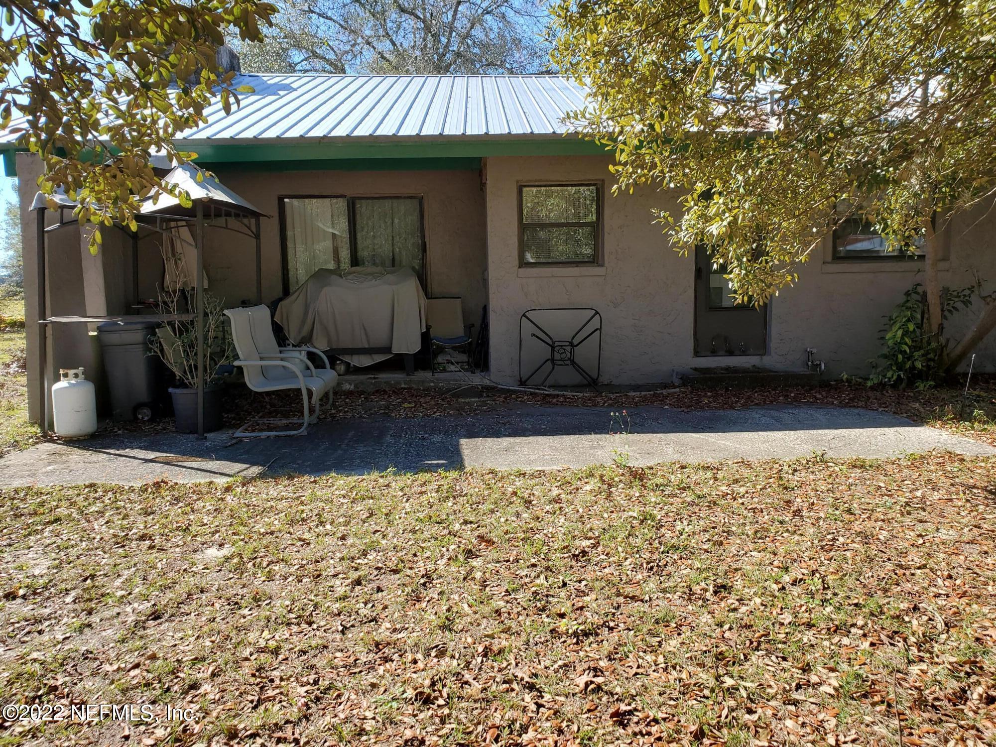 106 Comer Road Palatka, FL 32177 - Photo 4 of 19 a front view of a house with garden