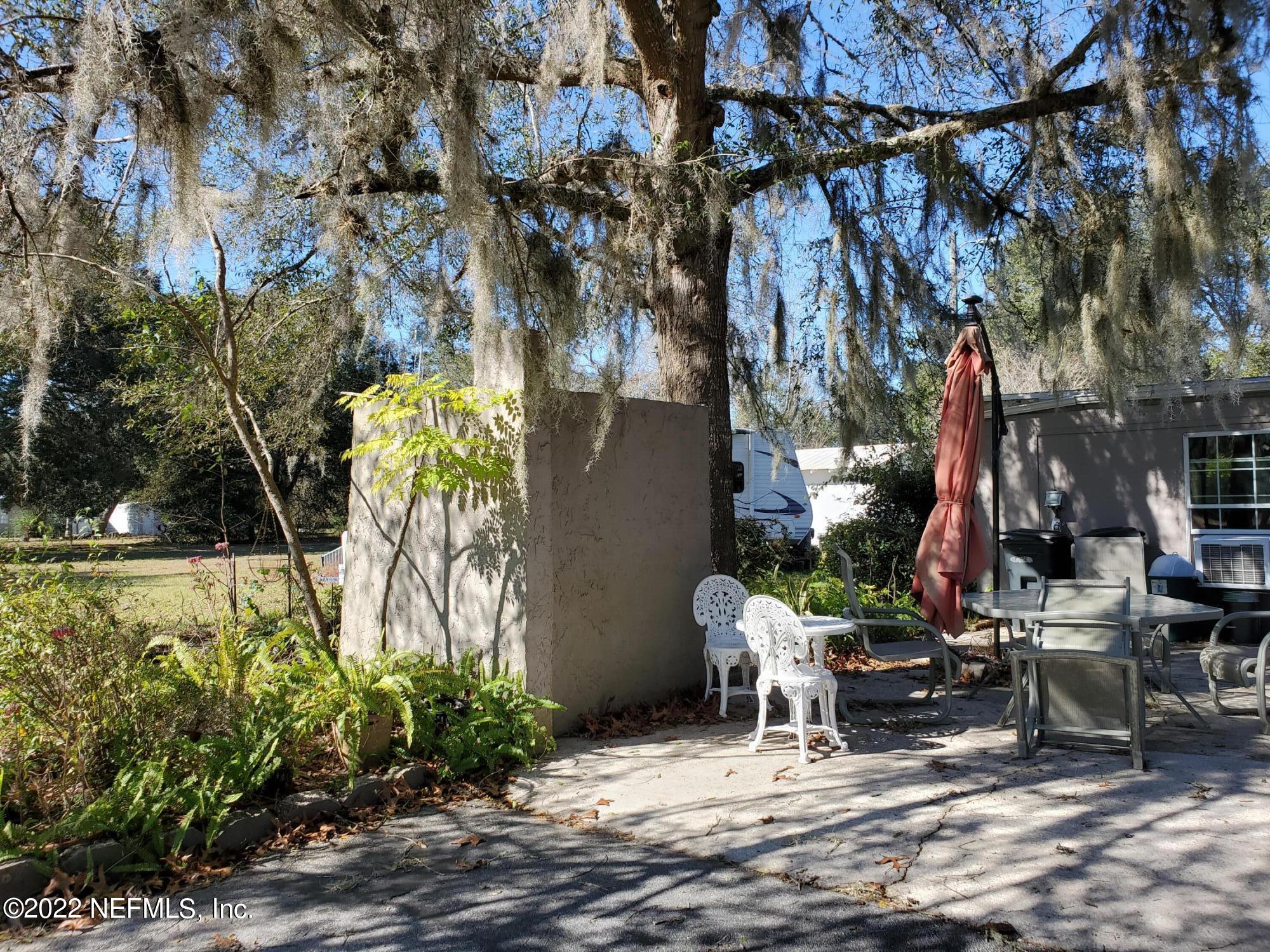 106 Comer Road Palatka, FL 32177 - Photo 6 of 19 a view of backyard with seating area and trees