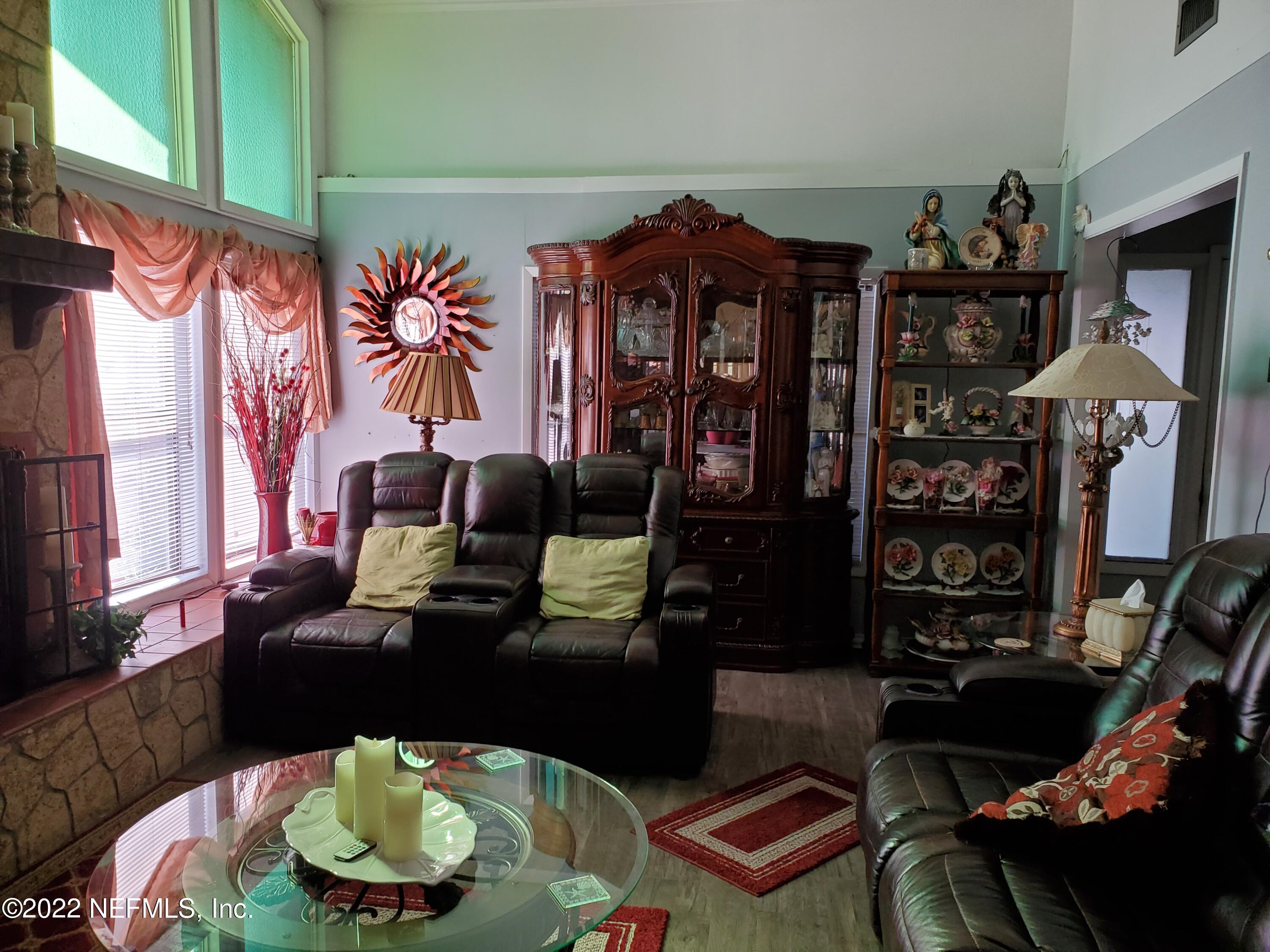 106 Comer Road Palatka, FL 32177 - Photo 7 of 19 a living room with furniture and a floor to ceiling window