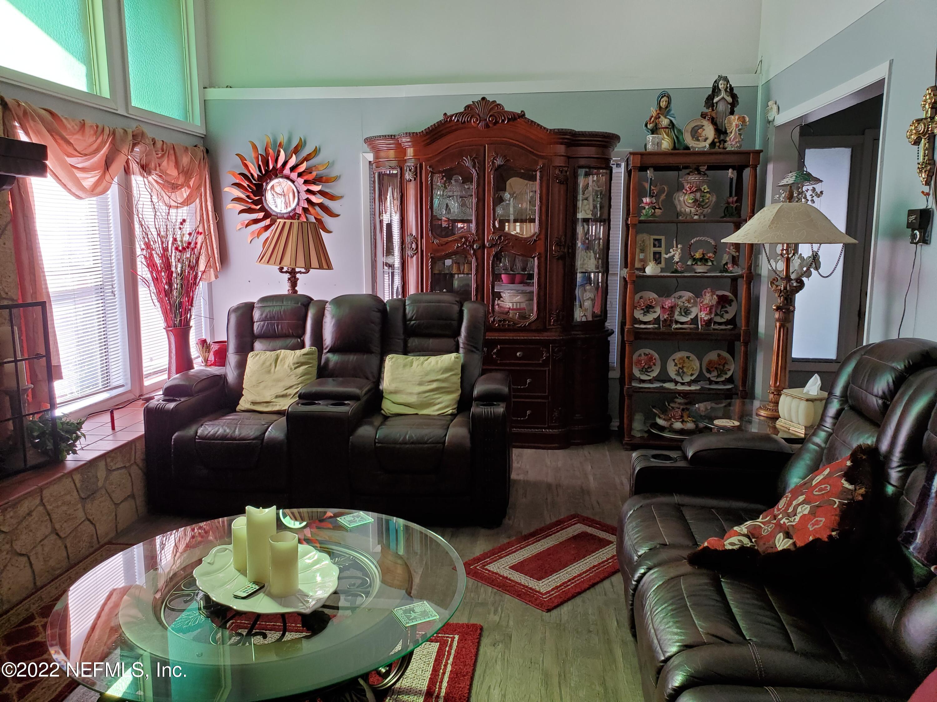 106 Comer Road Palatka, FL 32177 - Photo 8 of 19 a living room with furniture and a wooden floor