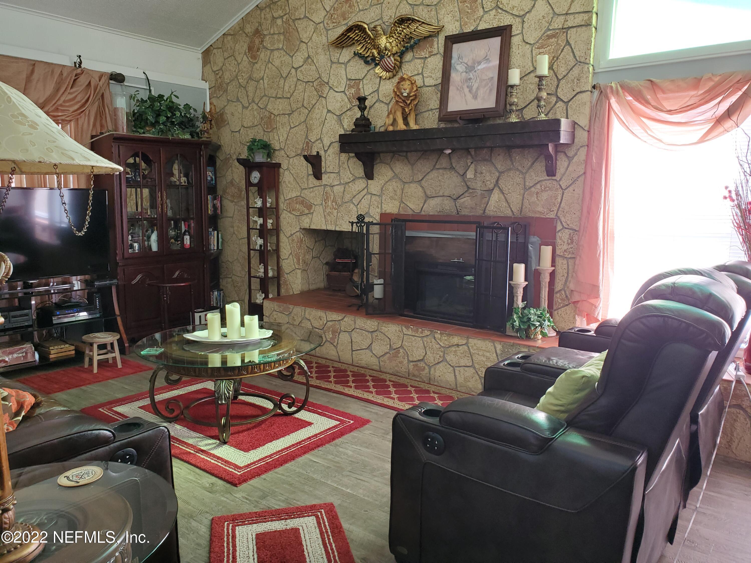 106 Comer Road Palatka, FL 32177 - Photo 9 of 19 a living room with furniture and a fireplace