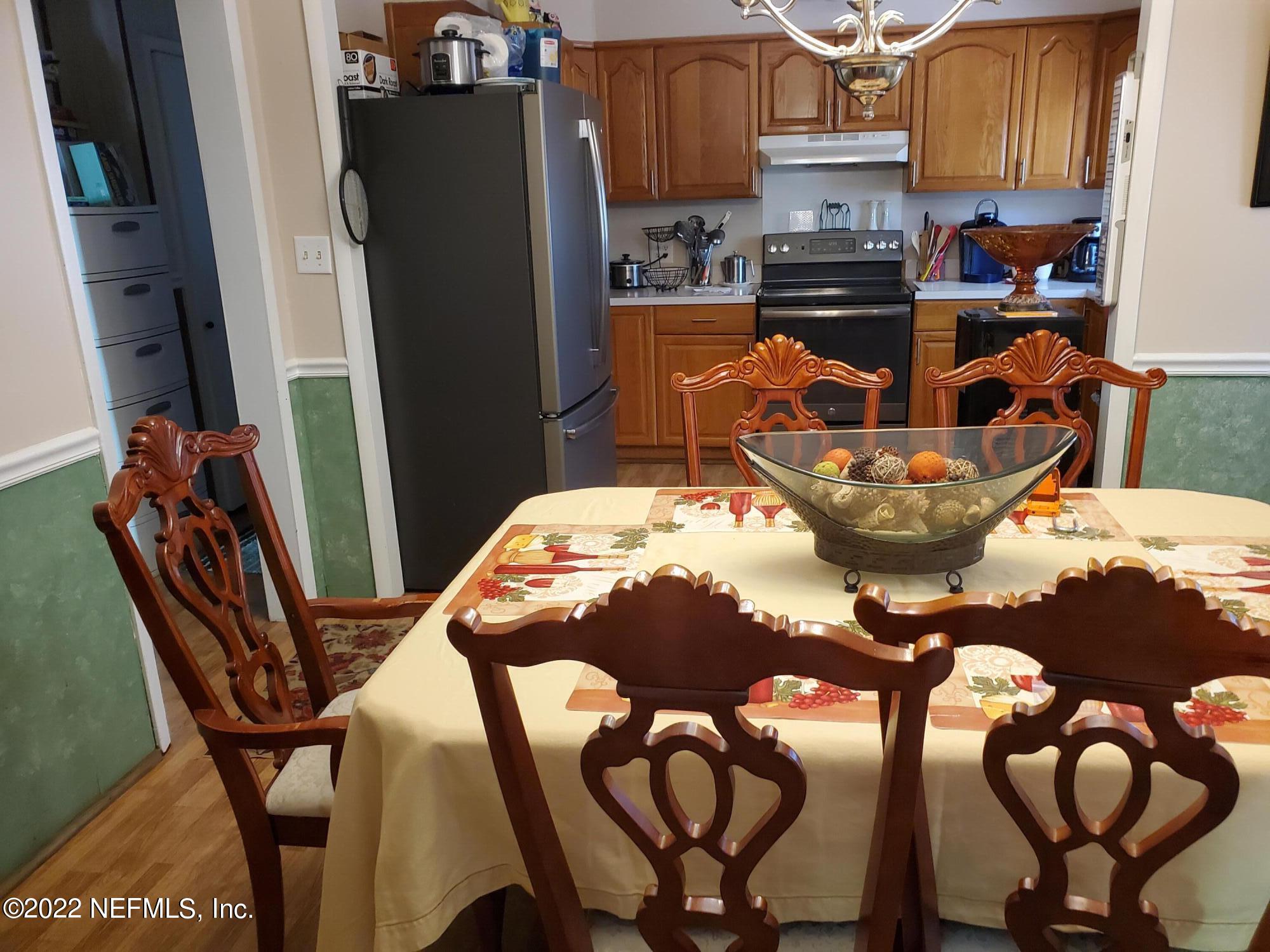106 Comer Road Palatka, FL 32177 - Photo 10 of 19 a kitchen with stainless steel appliances a dining table chairs and a sink