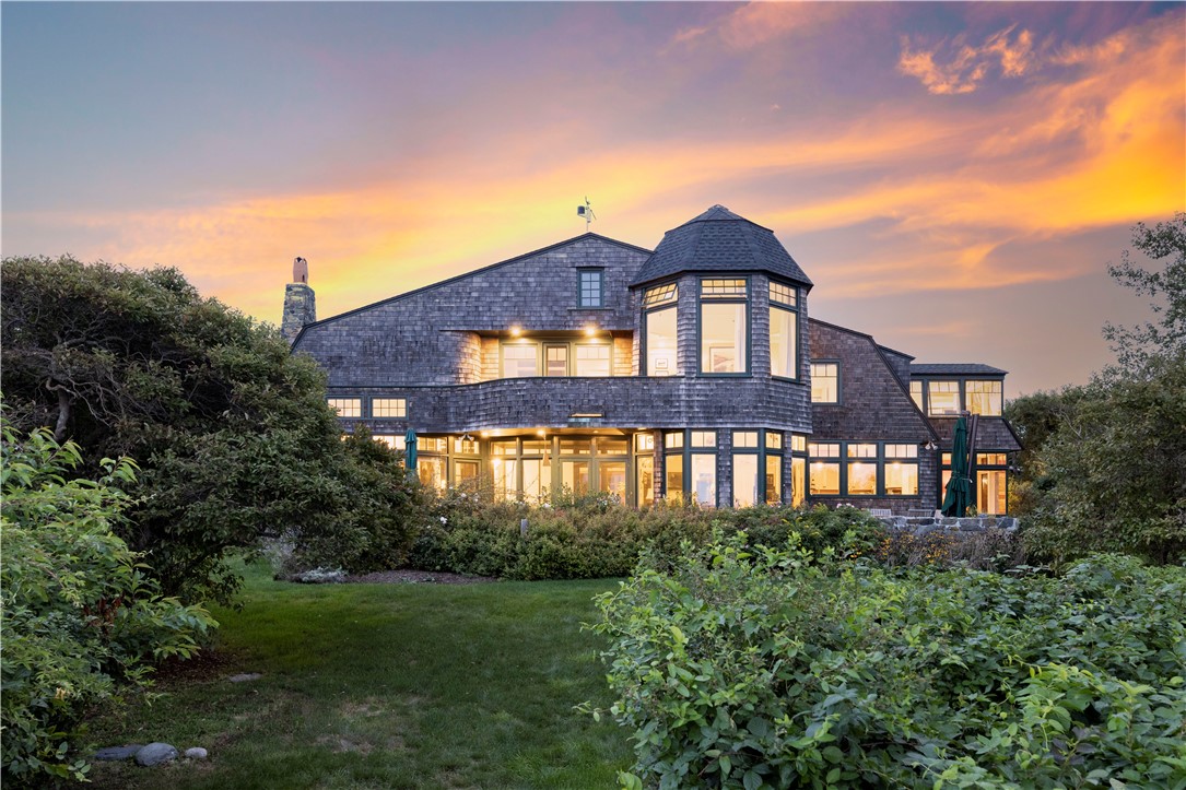 Exquisite architectural features include tower and elongated gambrel roof.