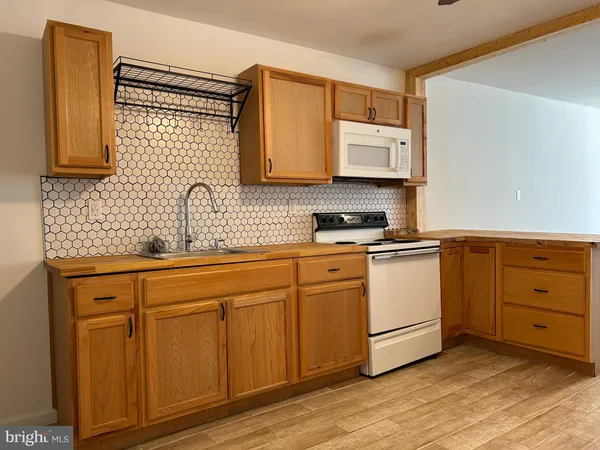 a kitchen with cabinets a sink and appliances
