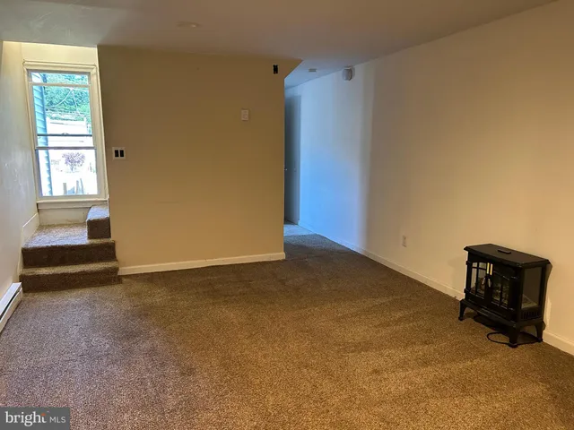 a view of an empty room and a window