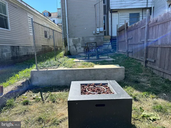 a wooden bench sitting in front of a house