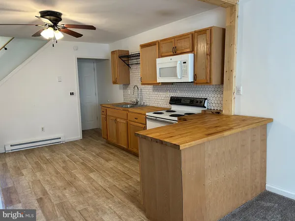 a kitchen with a stove cabinets and a window