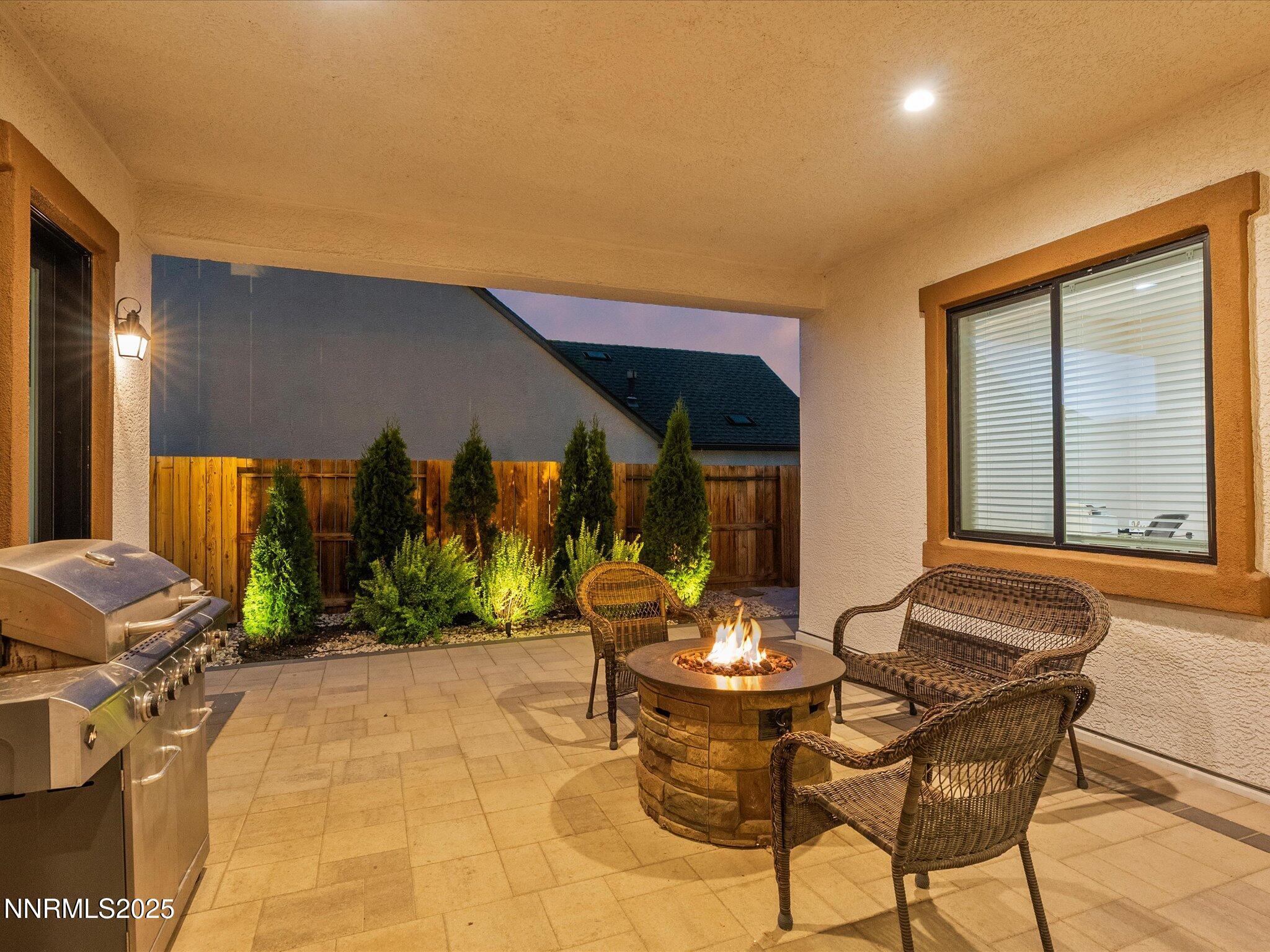 13545 Cobalt Sky Street Reno, NV 89521 - Photo 11 of 96 a view of a patio with a table and chairs and potted plants