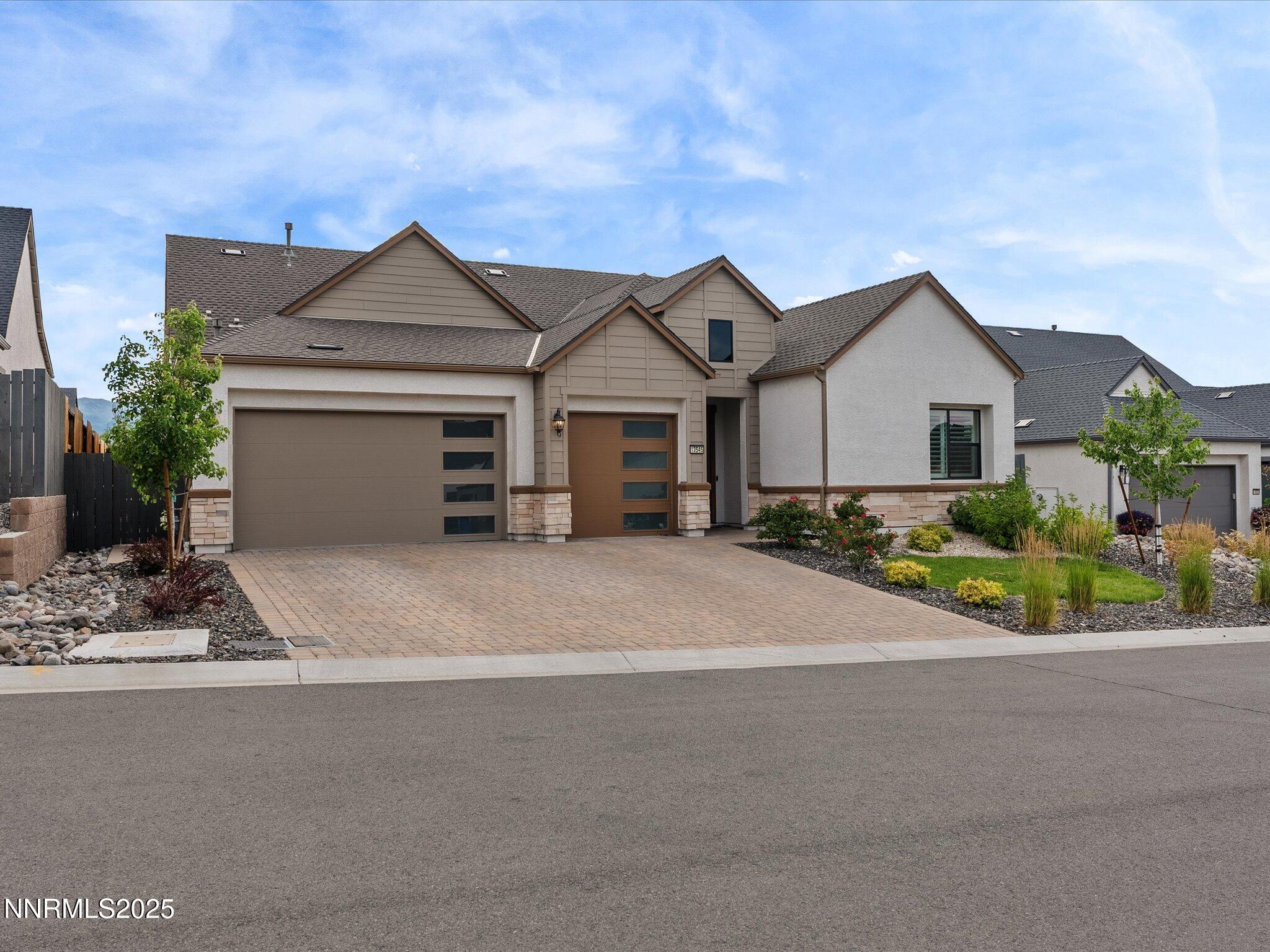 13545 Cobalt Sky Street Reno, NV 89521 - Photo 22 of 96 a front view of a house with a garden and yard