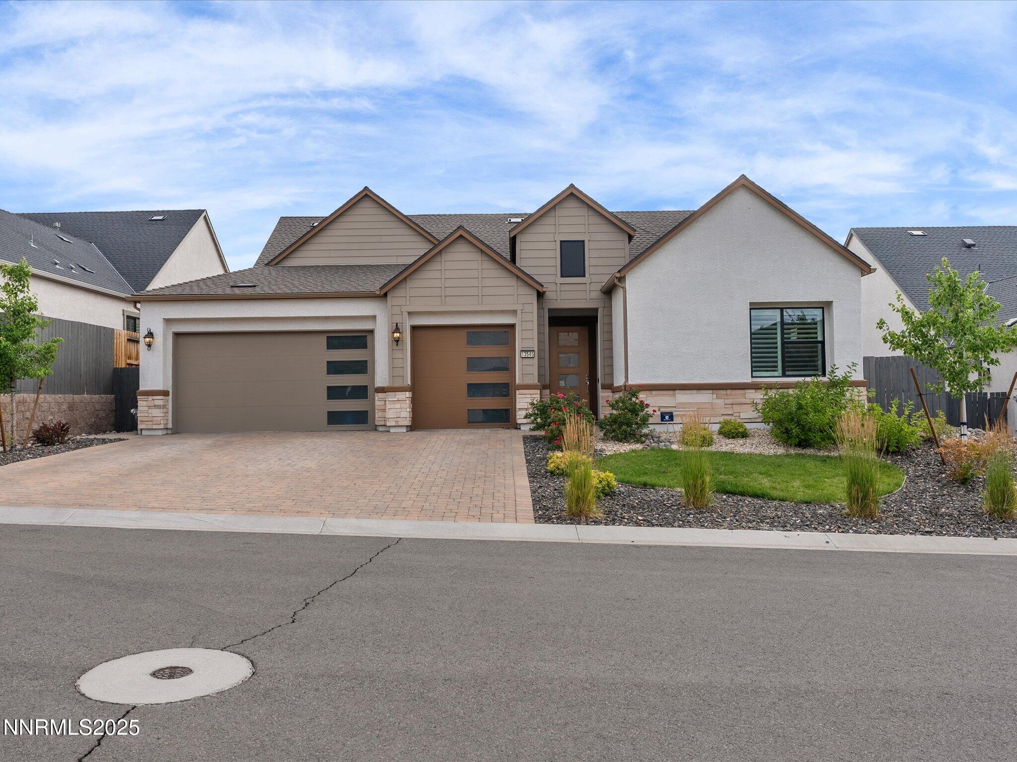 13545 Cobalt Sky Street Reno, NV 89521 - Photo 23 of 96 a front view of a house with a yard and garage