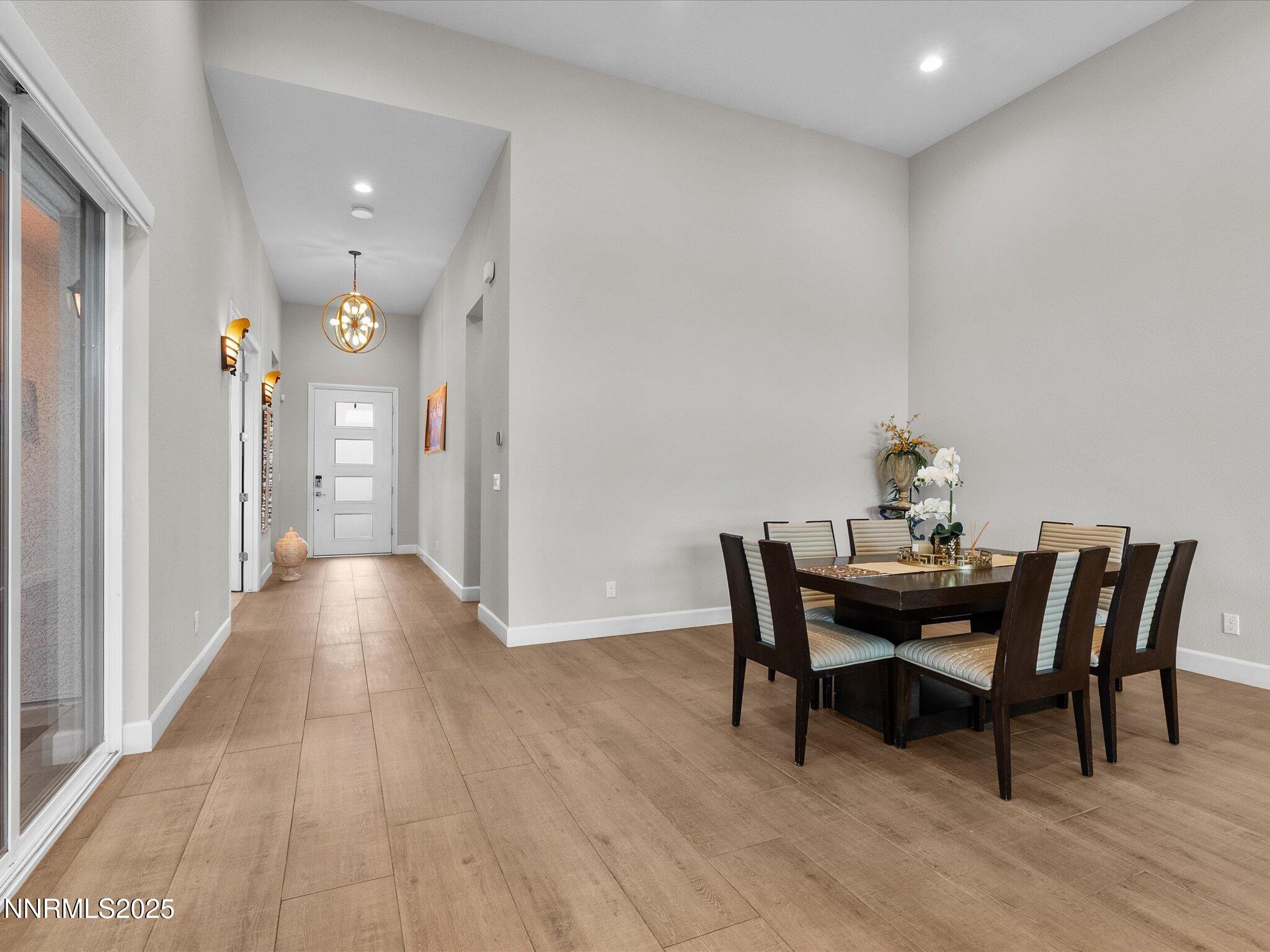 13545 Cobalt Sky Street Reno, NV 89521 - Photo 30 of 96 a view of a dining room with furniture and wooden floor