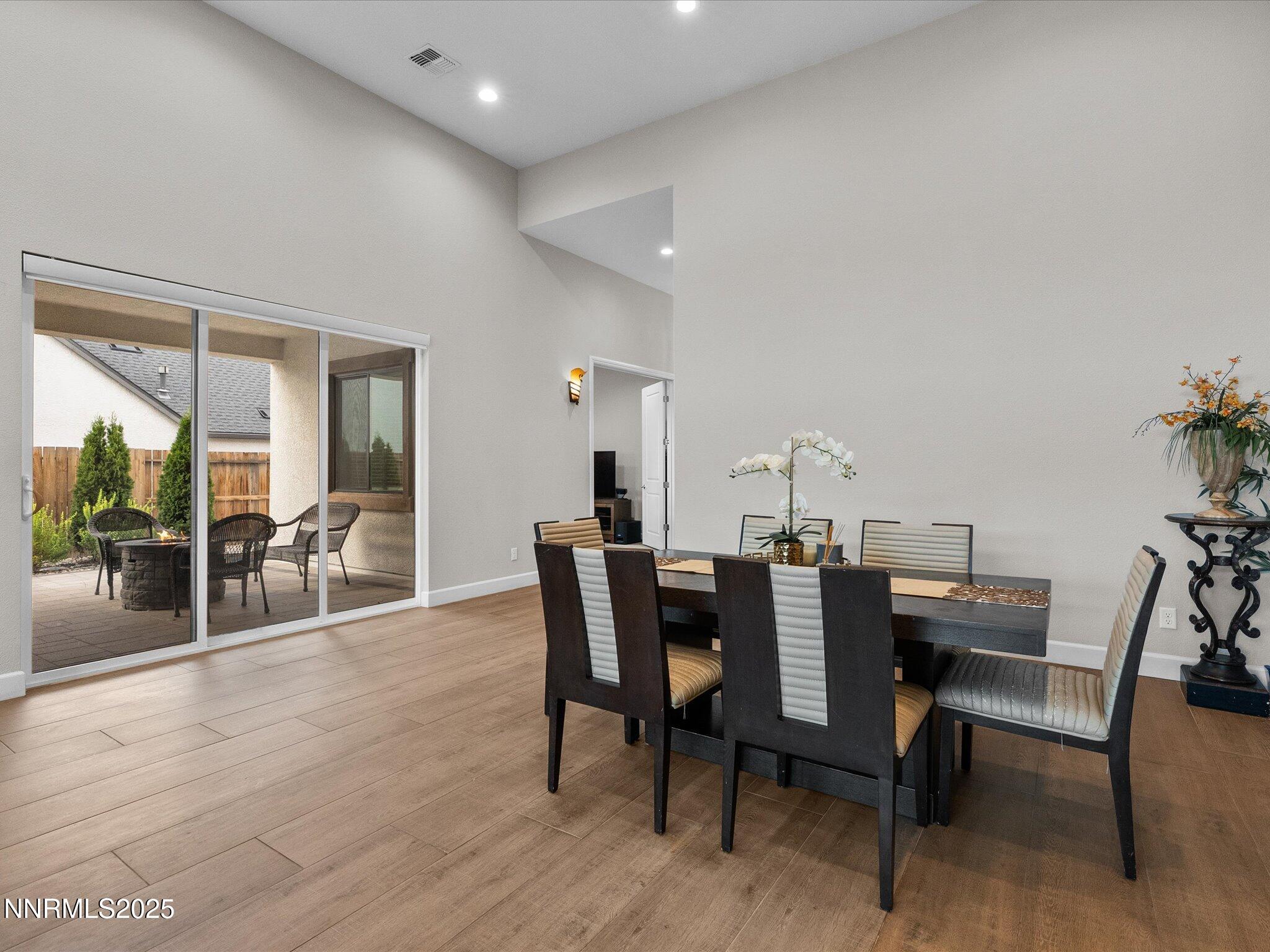 13545 Cobalt Sky Street Reno, NV 89521 - Photo 31 of 96 a view of a dining room with furniture and wooden floor
