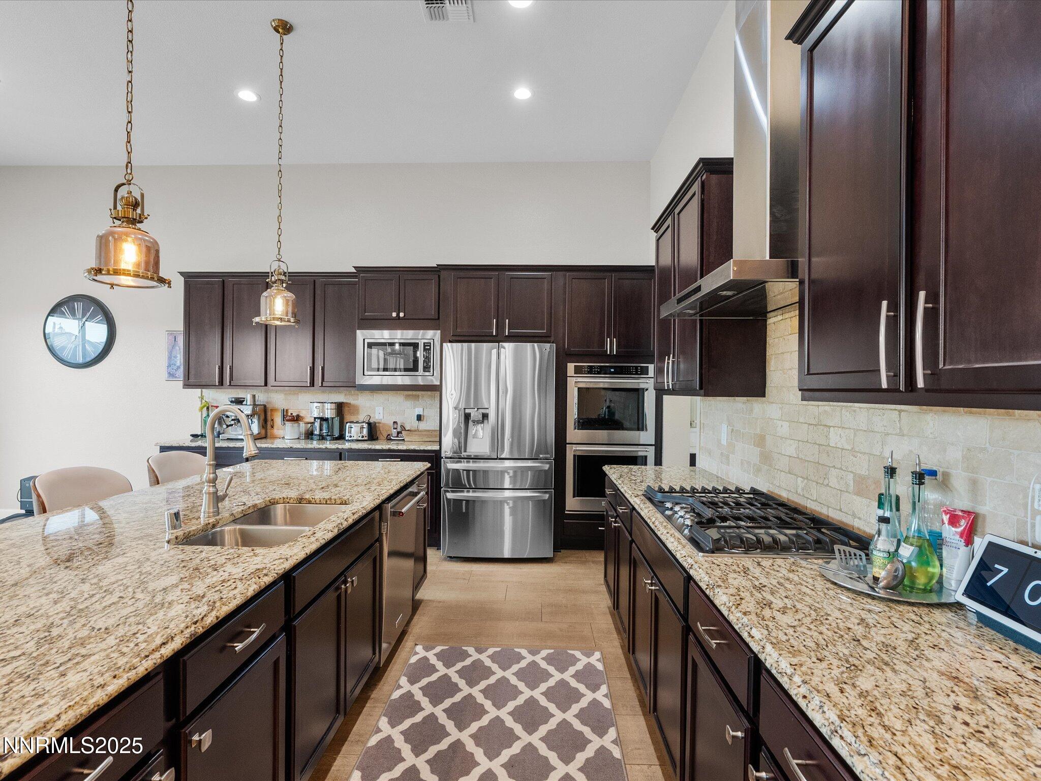 13545 Cobalt Sky Street Reno, NV 89521 - Photo 38 of 96 a kitchen with stainless steel appliances granite countertop a sink stove and refrigerator