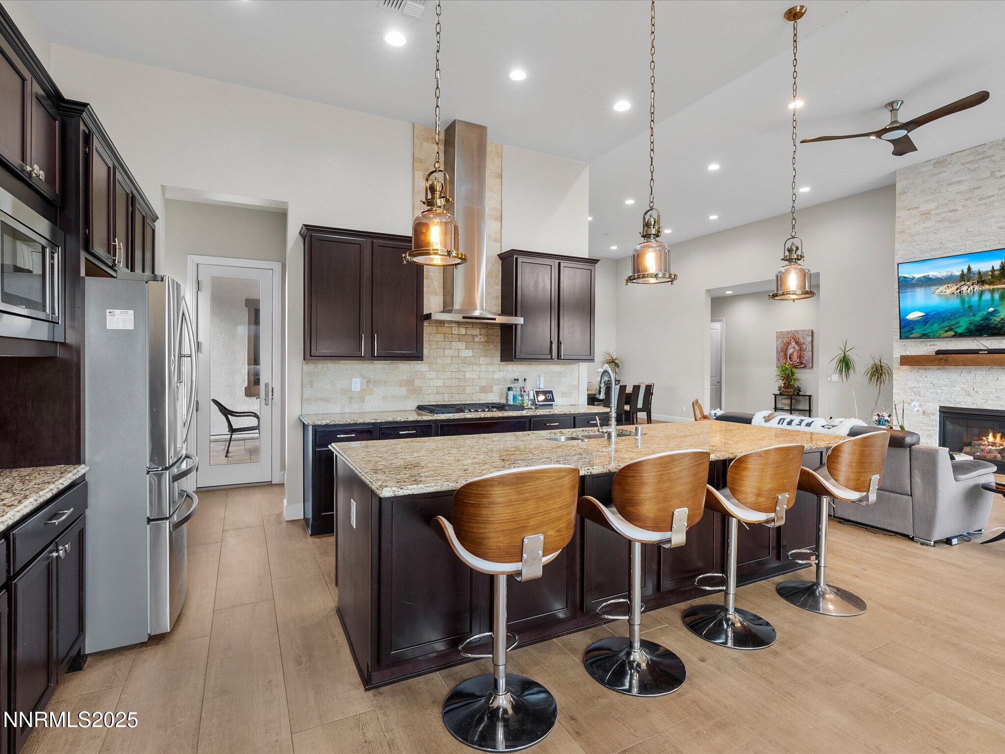 13545 Cobalt Sky Street Reno, NV 89521 - Photo 40 of 96 a large kitchen with a table chairs refrigerator and microwave