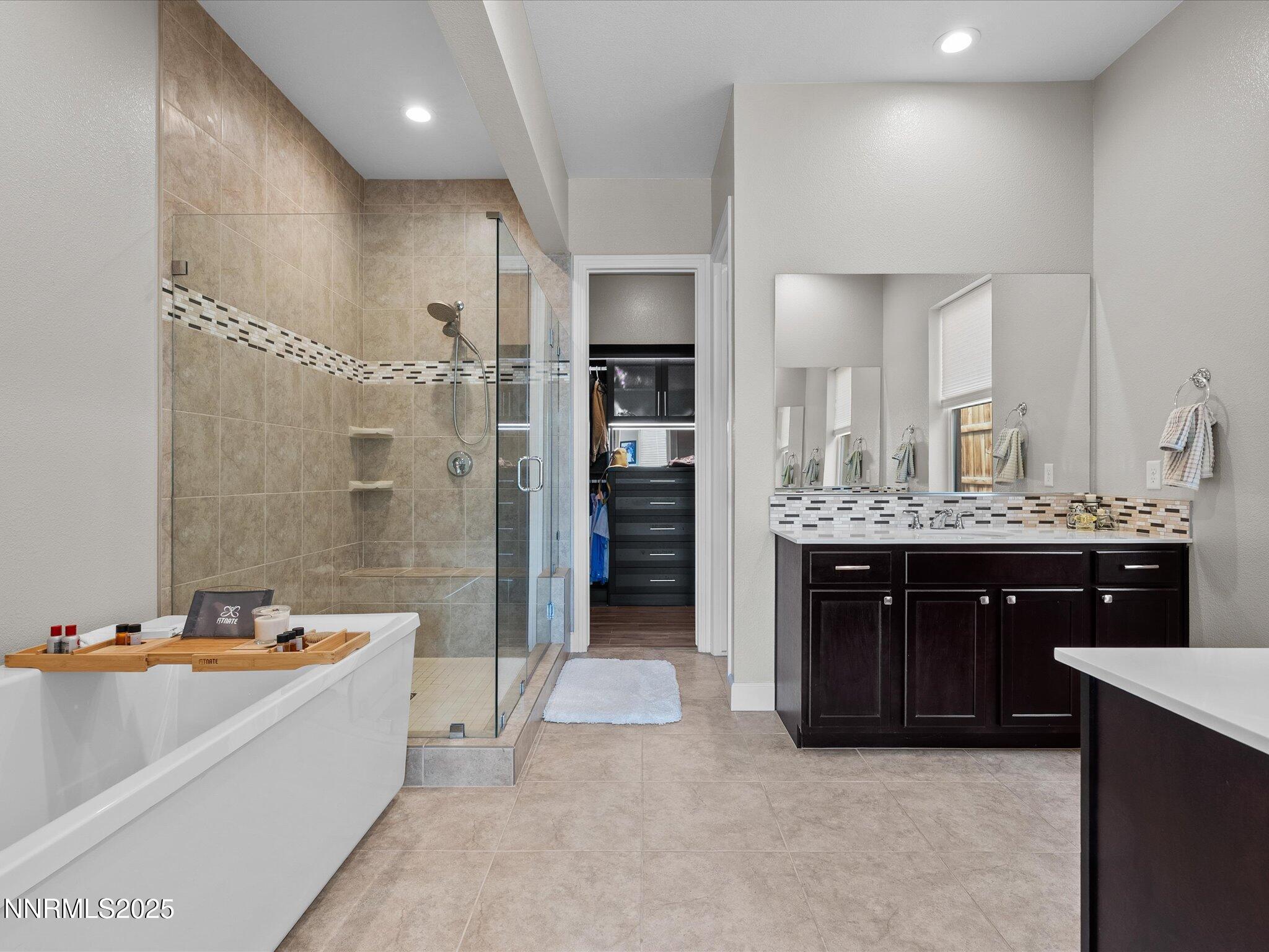13545 Cobalt Sky Street Reno, NV 89521 - Photo 47 of 96 a large bathroom with a double vanity sink a large mirror and a bathtub