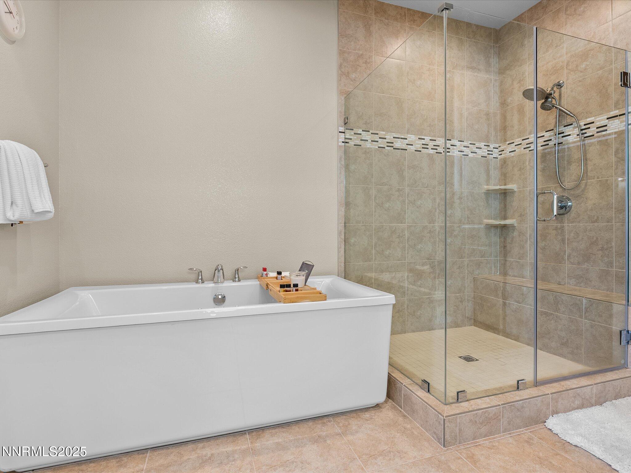 13545 Cobalt Sky Street Reno, NV 89521 - Photo 51 of 96 a bathroom with a tub a mirror and shower