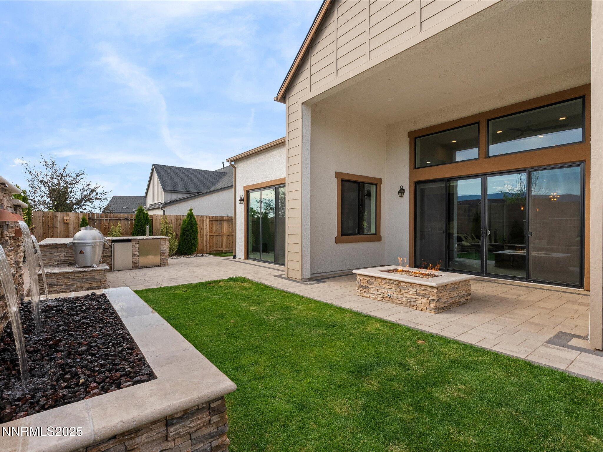 13545 Cobalt Sky Street Reno, NV 89521 - Photo 71 of 96 a view of a backyard with table and chairs and wooden fence