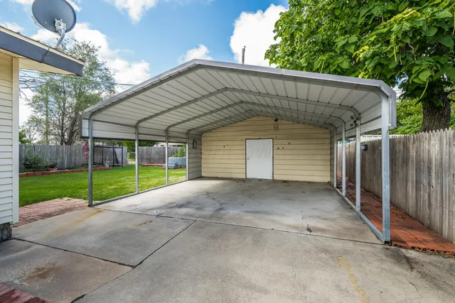 a view of a house with backyard and road
