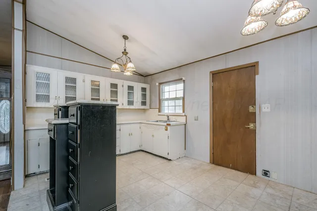 a view of kitchen with windows and refrigerator