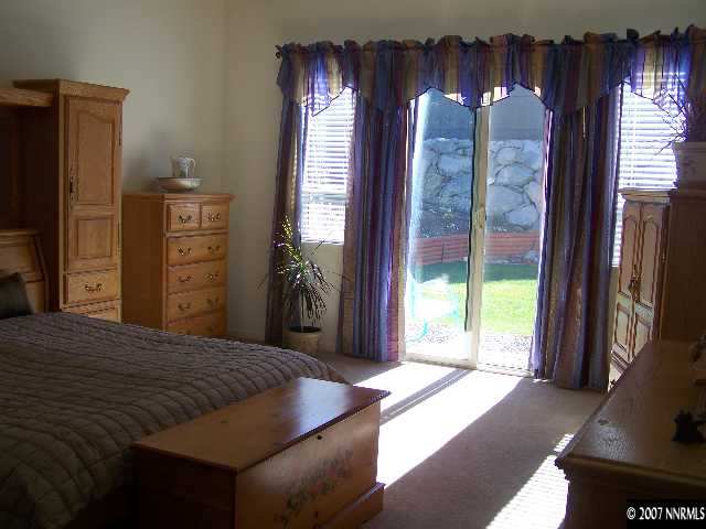 880 Sienna Reno, NV 89512 - Photo 5 of 9 a bedroom with a bed and a large window