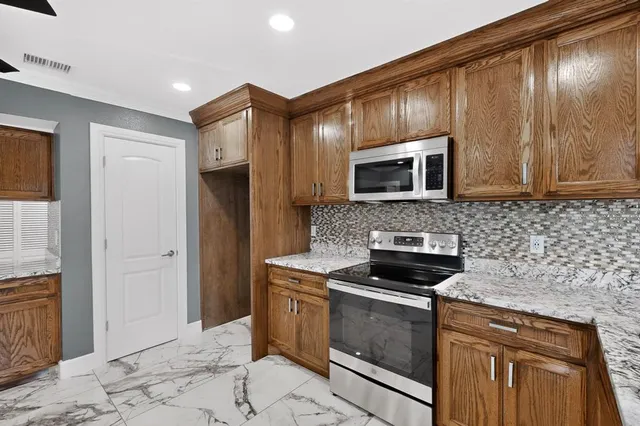 a kitchen with sink cabinets and microwave