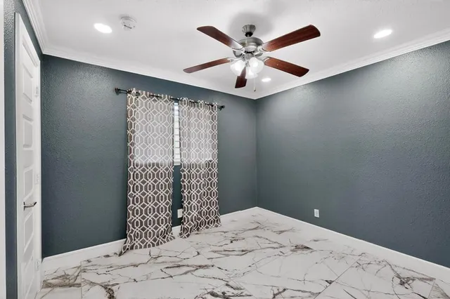 a view of a bedroom with a bed and a window