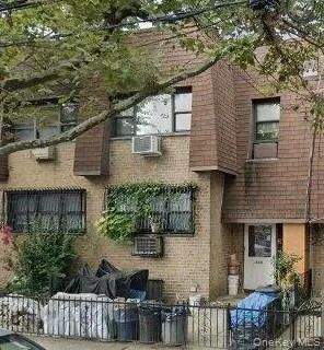 a front view of a house with plants