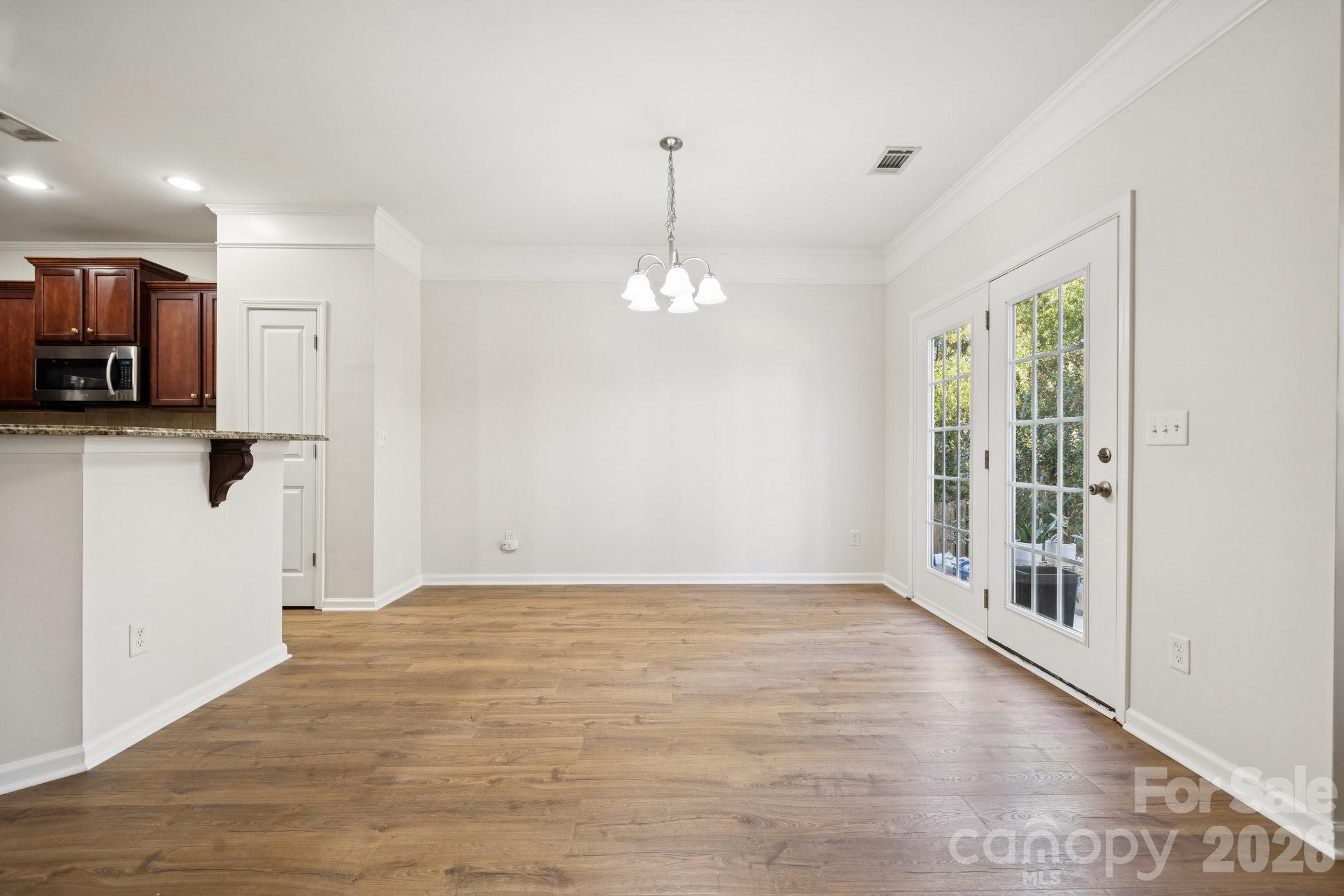 2015 Terrapin Street Indian Trail, NC 28079 - Photo 11 of 30 a view of a room with stainless steel appliances wooden floor and a large window