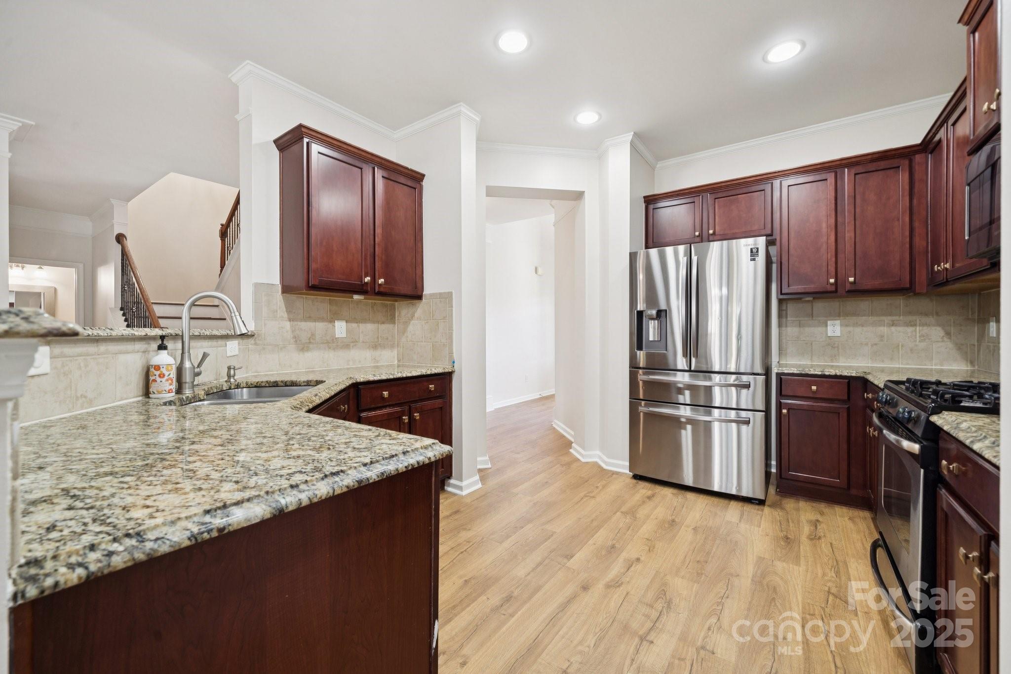 2015 Terrapin Street Indian Trail, NC 28079 - Photo 12 of 31 a kitchen with granite countertop a refrigerator stove and oven