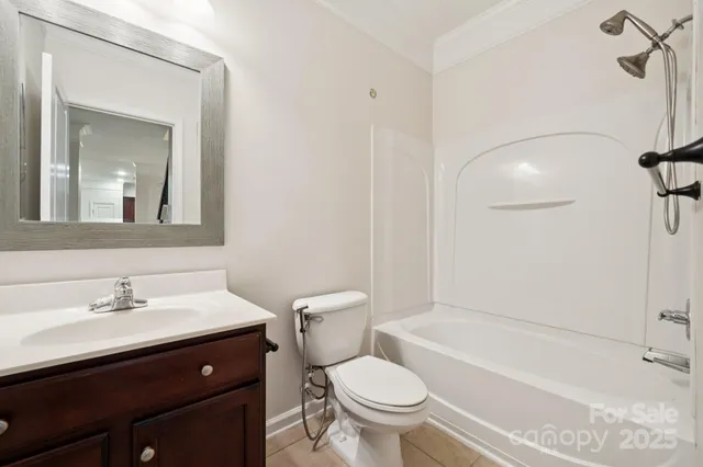 a bathroom with a sink toilet vanity and bathtub
