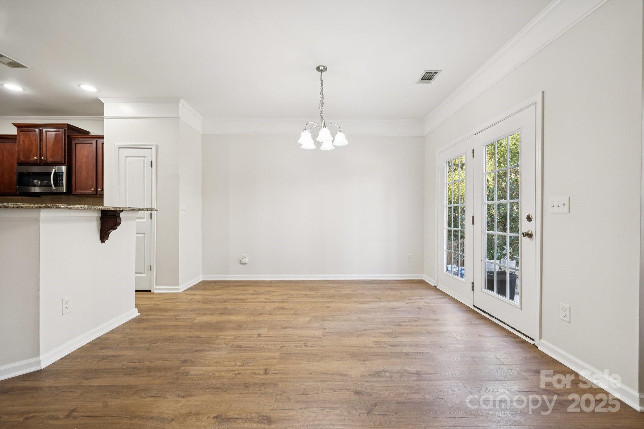 2015 Terrapin Street Indian Trail, NC 28079 - Photo 7 of 28 a view of a room with stainless steel appliances wooden floor and a large window