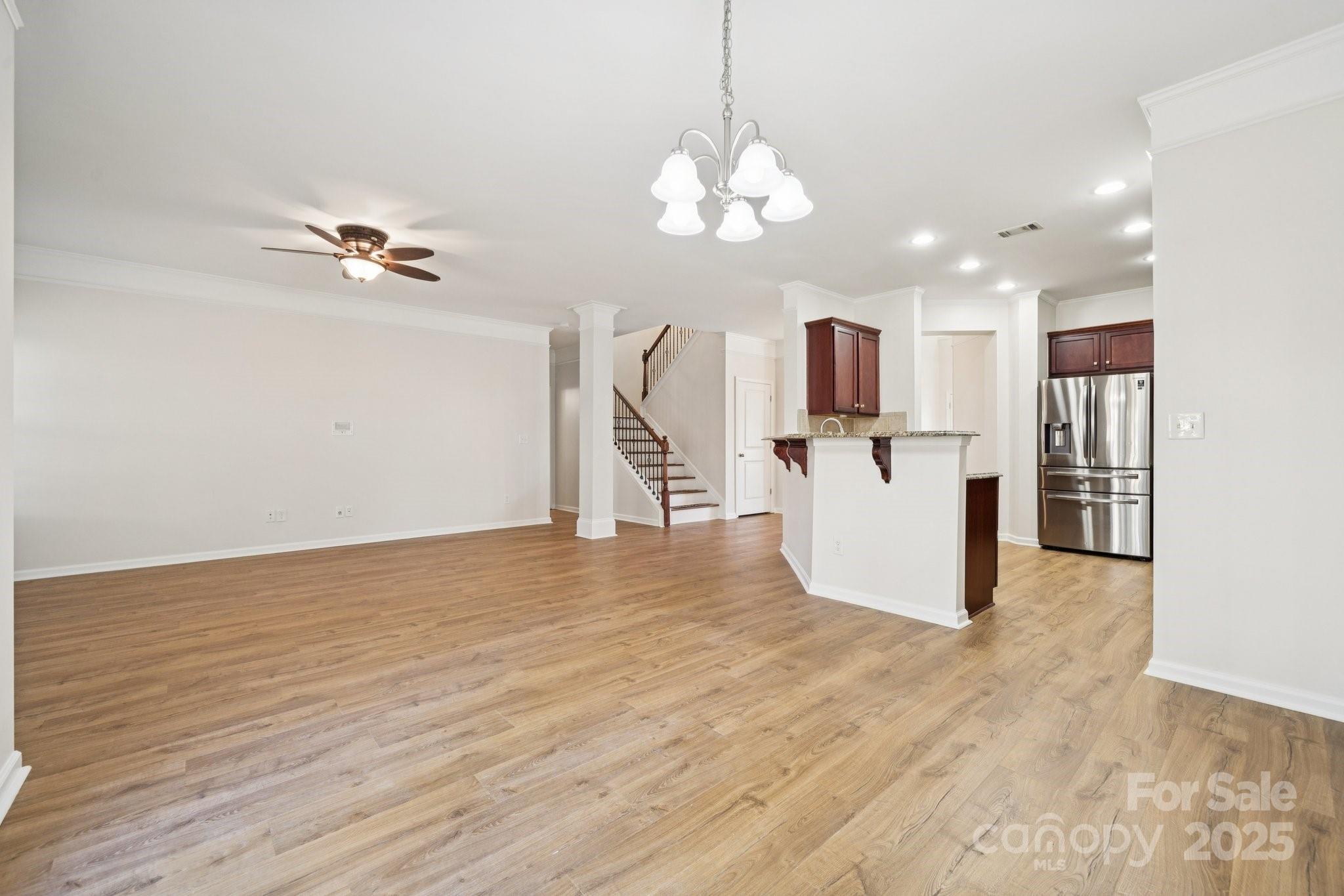 2015 Terrapin Street Indian Trail, NC 28079 - Photo 8 of 28 a view of a kitchen with wooden floor and a chandelier