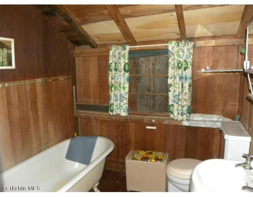 111 Rowe Road Charlemont, MA 01339 - Photo 9 of 17 a bath tub sitting in a bathroom next to a window