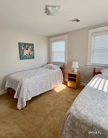 a spacious bedroom with a bed and a couch