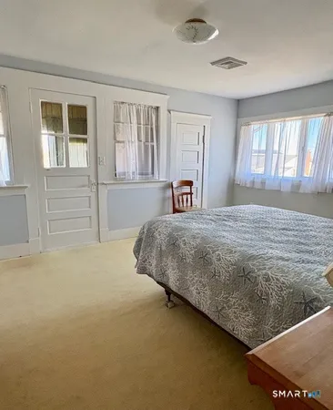 a bedroom with a bed and window