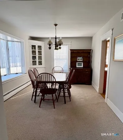 a dining room with furniture and window