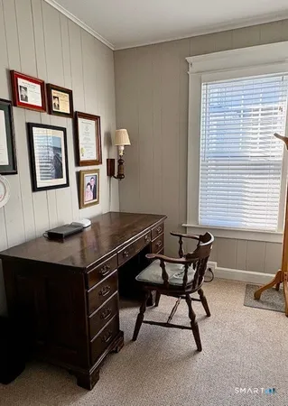 a reading room with furniture and window
