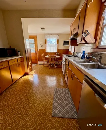 a kitchen with sink refrigerator and cabinets