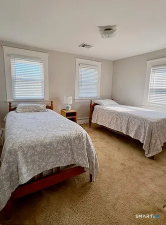 a bedroom with bed and window