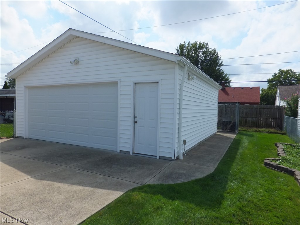 7701 Spring Garden Road Cleveland, OH 44129 - Photo 23 of 27 Garage featuring garage and a yard