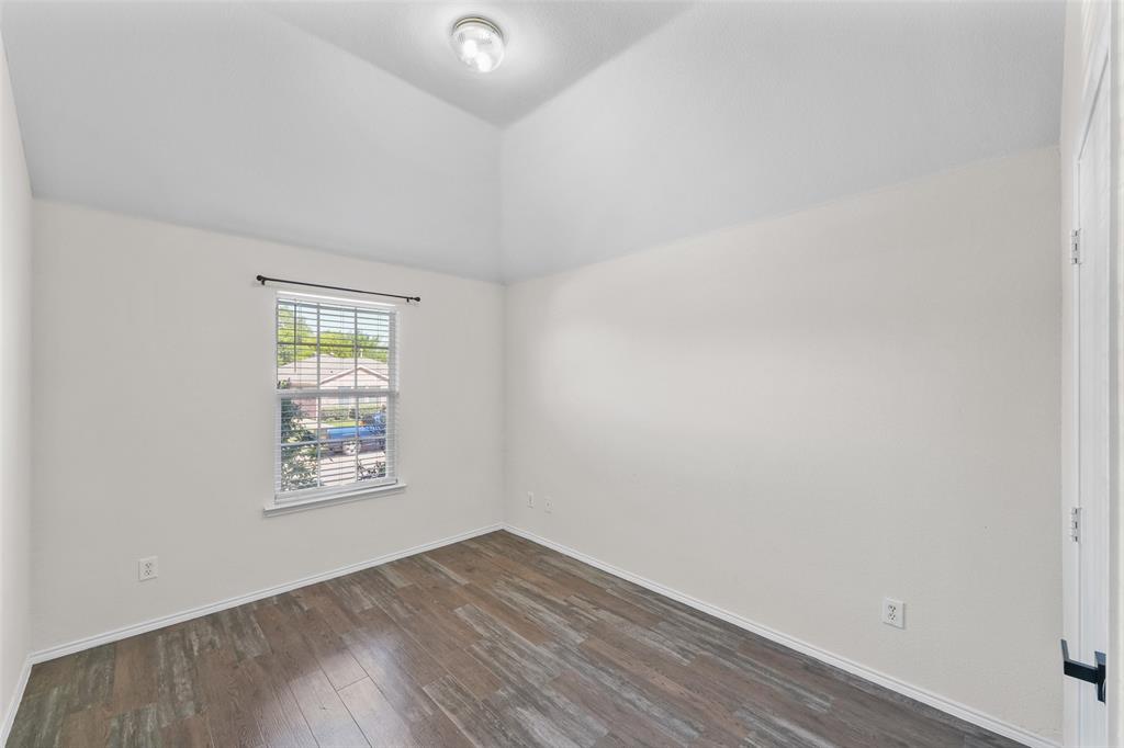 2124 Hickory Ridge Drive Mesquite, TX 75181 - Photo 11 of 16 an empty room with wooden floor and windows