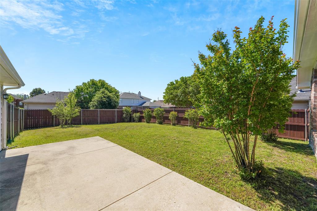 2124 Hickory Ridge Drive Mesquite, TX 75181 - Photo 14 of 16 a view of a backyard with large trees