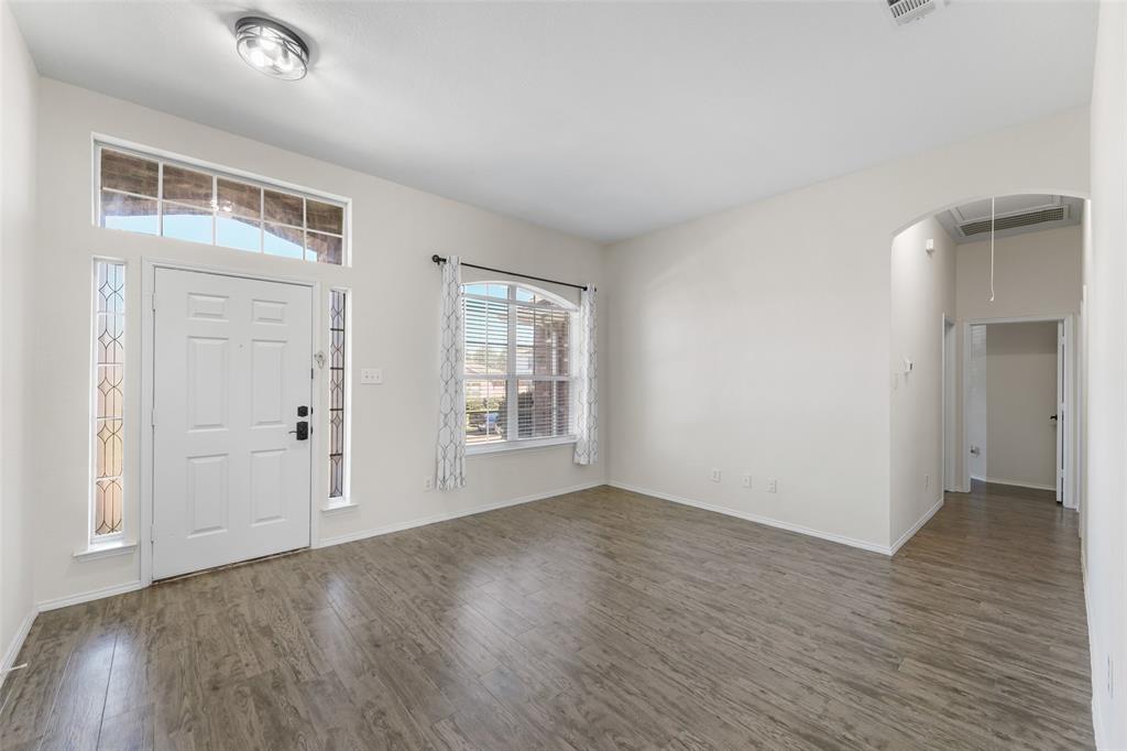 2124 Hickory Ridge Drive Mesquite, TX 75181 - Photo 3 of 16 an empty room with wooden floor and windows