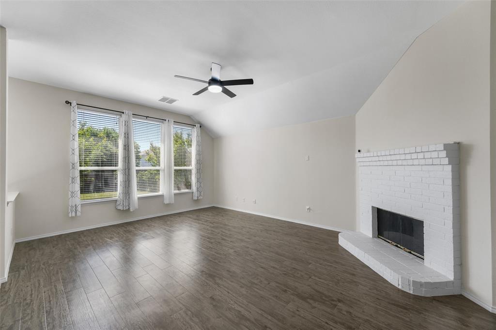 2124 Hickory Ridge Drive Mesquite, TX 75181 - Photo 5 of 16 a view of empty room with wooden floor and fireplace